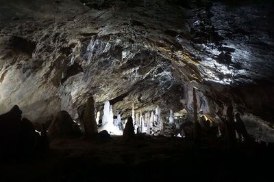 Low angle view of silhouette people in cave