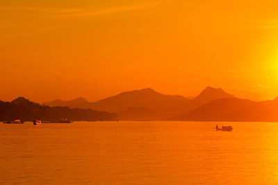 Scenic view of sea against orange sky
