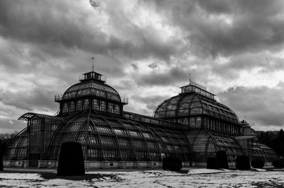 Facade of building against cloudy sky