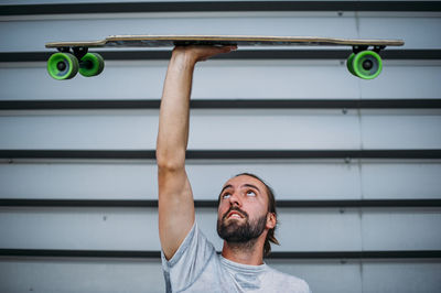 A boy launches skateboard up