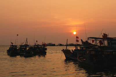 Fishing boats moored at nam du island against sky during sunset