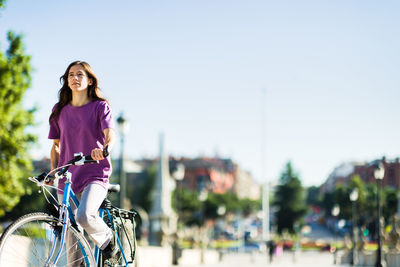 Portrait of young woman standing on street