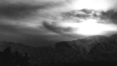 Scenic view of mountains against cloudy sky