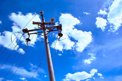 Low angle view of cables against blue sky