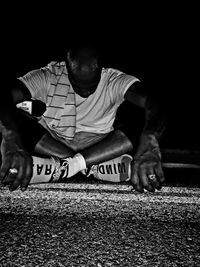 Full length of man sitting on carpet