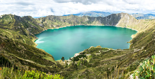 Scenic view of mountains against cloudy sky