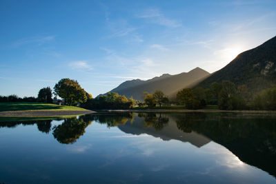 Scenic view of lake and mountains against sky