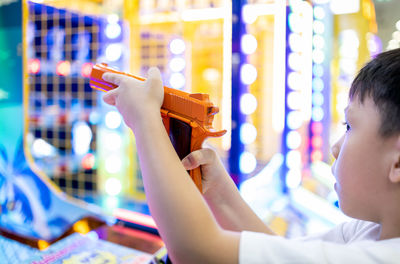 Close-up of boy holding illuminated lighting equipment