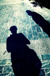 Shadow of man on footpath