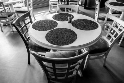 High angle view of empty chairs and tables at restaurant