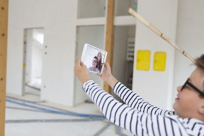 Portrait of young woman using mobile phone