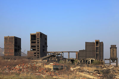 Abandoned buildings against blue sky