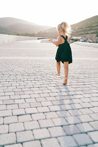 Rear view of woman walking on street