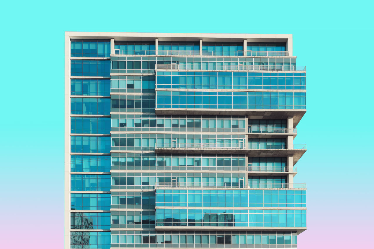 LOW ANGLE VIEW OF MODERN BUILDINGS AGAINST CLEAR BLUE SKY