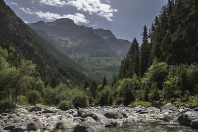 Scenic view of river amidst mountains against sky