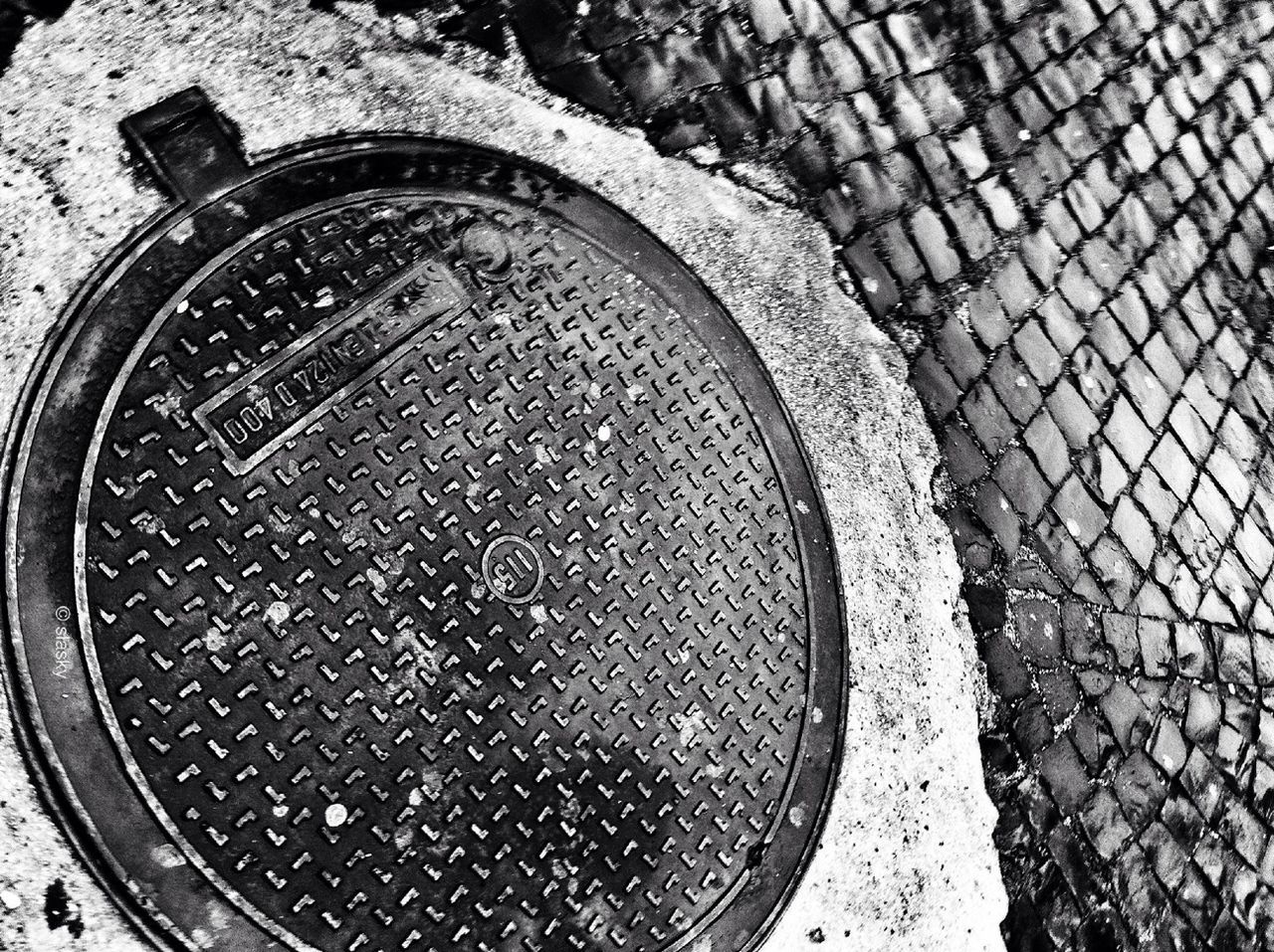 circle, metal, high angle view, geometric shape, close-up, manhole, metallic, directly above, no people, communication, day, old, number, outdoors, textured, rusty, street, hole, pattern, shape