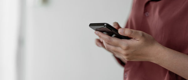Midsection of woman using mobile phone