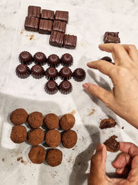 Cropped hand of woman holding cookies