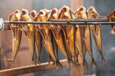 Dry smoked spiced and marinated salmon in a regional street food market with smoke on background