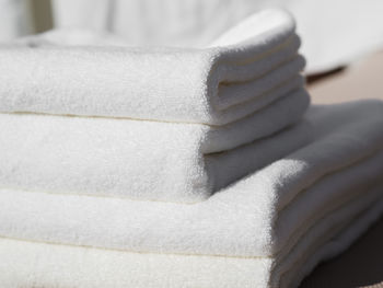 Close-up of woman sitting on bed at home