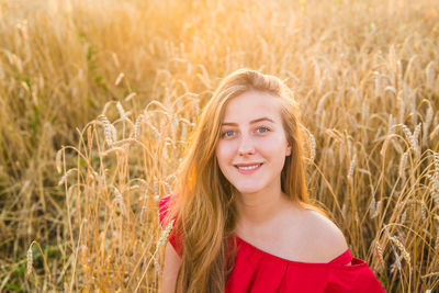 Portrait of smiling young woman in field