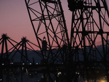 Silhouette of ferris wheel at night