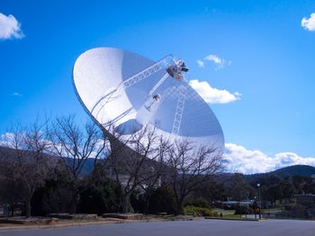 Satellite dish on field against sky