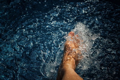 Low section of woman on water