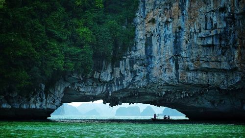 Scenic view of sea against rock formation in ha long bay