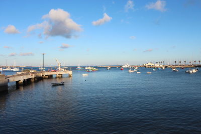 Sailboats in sea against sky