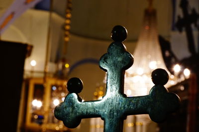 Close-up of statue against illuminated building