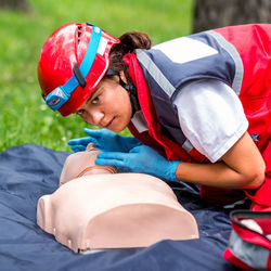 Healthcare worker practicing on cpr dummy at park