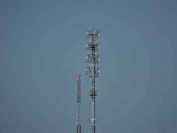 Low angle view of communications tower against sky