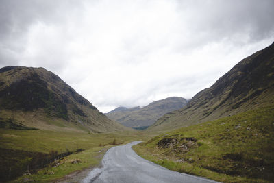 Road amidst mountains against sky