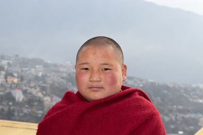 Teen buddhist monk portraits close up with details at day from flat angle