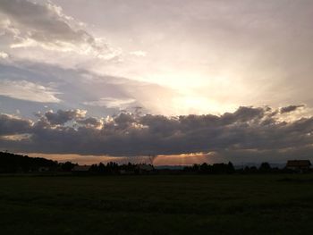 Scenic view of field against sky during sunset