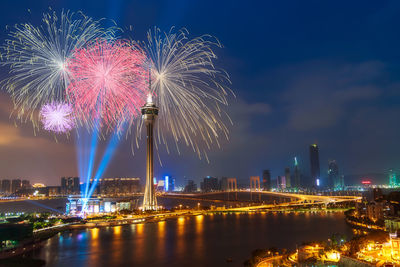 Firework display over river at night