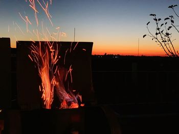 Firework display against sky at night