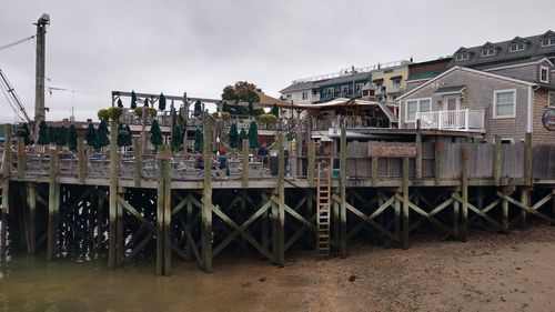 Panoramic view of railroad tracks by buildings against sky