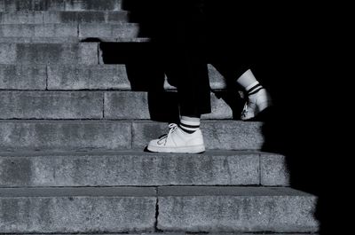 Low section of woman sitting on staircase