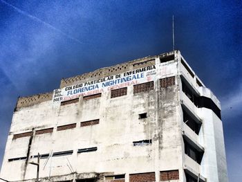 Low angle view of building against blue sky