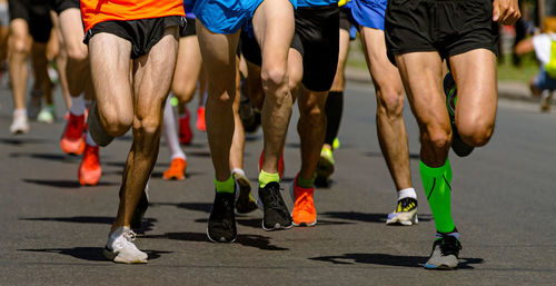 Low section of people walking on road