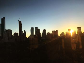 Cityscape against clear sky during sunset