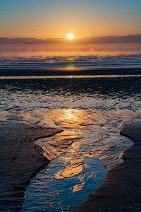 Scenic view of sea against sky during sunrise