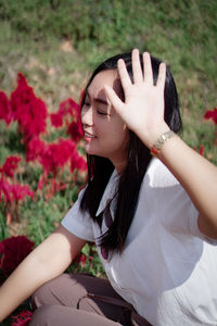 Young woman sitting on field