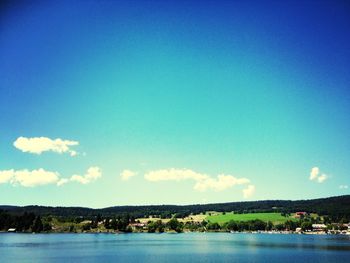 Scenic view of calm sea against mountain range