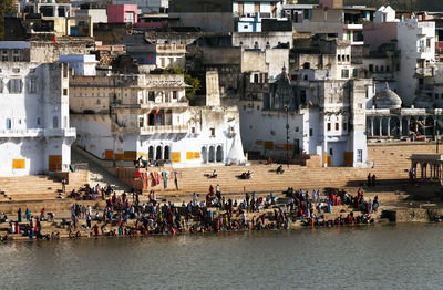 Pilgrims at pushkar lake on sunny day