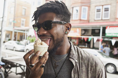 A young man eating frozen yogurt