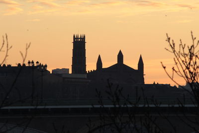 Silhouette of building against sky during sunset