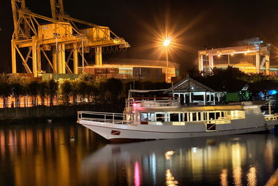 Boat moored on lake at night